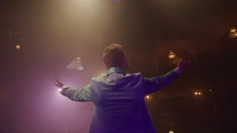 Back shot of Man on the Stage in a suit welcoming the audience Stock Footage 270483693