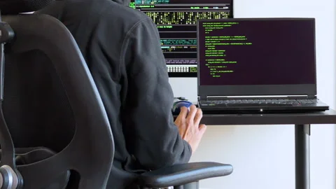 Back shot of a man tapping on desk while waiting for code to execute Stock Footage 146607087