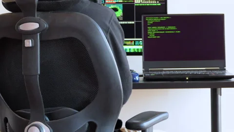 Back shot of a man typing on a keyboard and working as hacker Stock Footage 146606872
