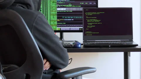 Back shot of a man waiting for code to execute, hacker sitting on a chair Stock Footage 146607158
