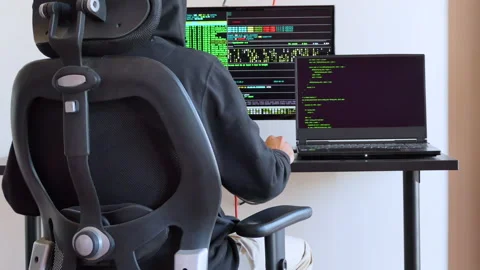 Back shot of a man working on a computer as hacker Stock Footage 146606714