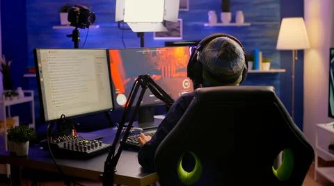 Back shot of pro streamer with headphone Фото