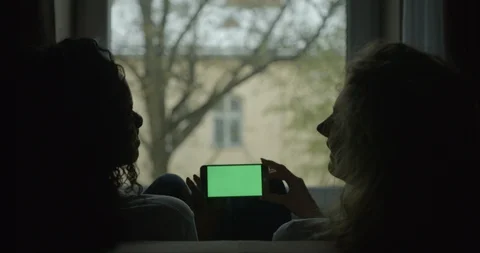 Back shot of two multi-raced brunette and blonde girl friends happily talking Stock Footage 86363750