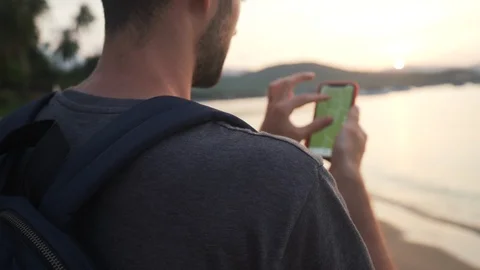 Back Shot of Young Man 4K Searching in Smartphone Map on Beach. Stock Footage 109088454