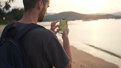 Back Shot of Young Man 4K Searching in Smartphone Map on Beach. Stock Footage 109088736