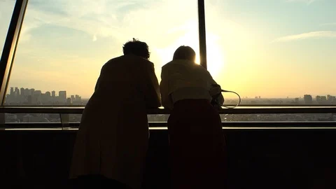 Back shot of young man and woman in sunset. Stock Footage 106905506