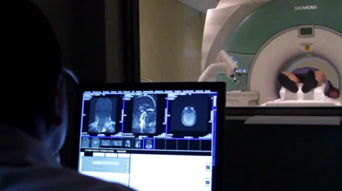 BACK SHOULDER. Doctor looking a monitor during a brain scan. Stock Footage