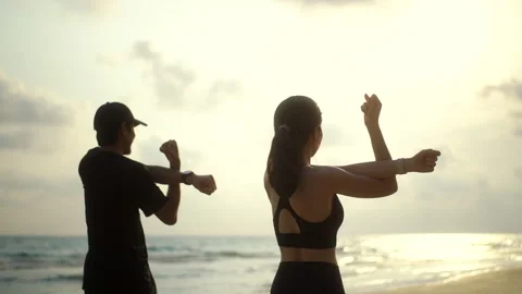 Back side couple young two friends stretching arm before running at seaside. Video stock 272950517