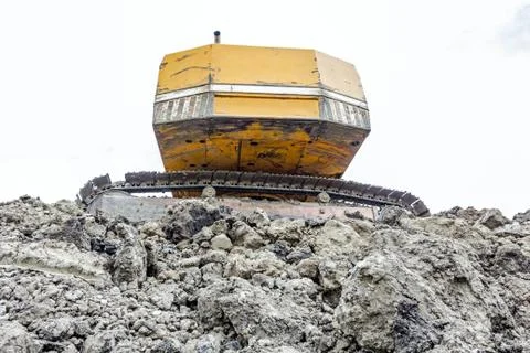 Back side of crawler excavator on pile of ground at building site, close view Stock Photos