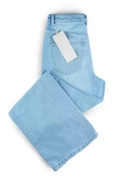Back side of folded blue jeans with pocket and blank label tag with copy sp.. Stock Photos