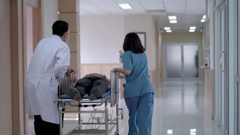 Back side of medical team pushing emergency stretcher bed. Stock Footage 138789868