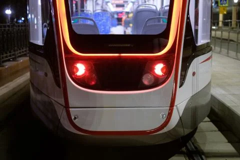 Back side of modern city low floor city tram on bus top in night Stock Photos