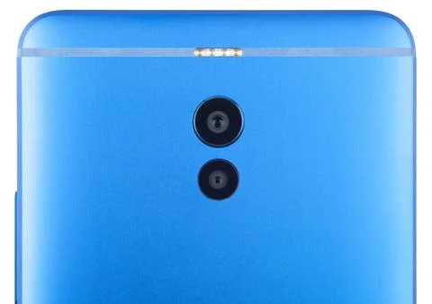The back side of the modern smartphone close-up. Isolated on white background. Stock Photos