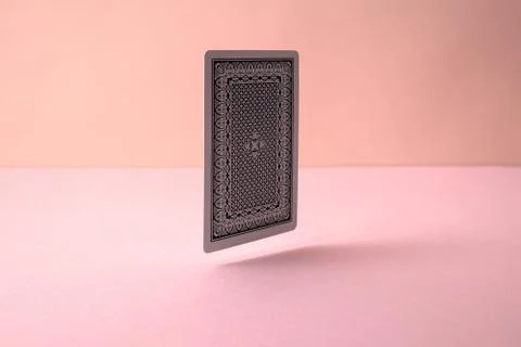 Back side of playing card on pink background.	 Stock Photos