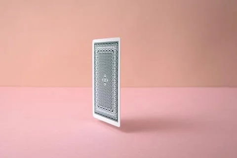 Back side of playing card on pink background.	 Foto stock