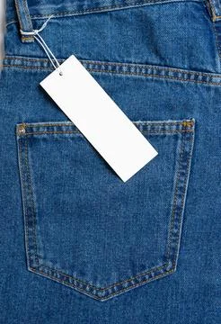Back side pocket of blue jeans pants and price tag close-up background, moc.. Stock Photos