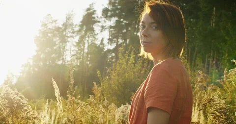 Back side portrait of red haired girl backlit with setting sunlight slow motion Stock Footage 140756278