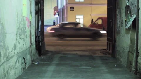 Back side of running man with green backpack out courtyard on right Vidéo 59804469