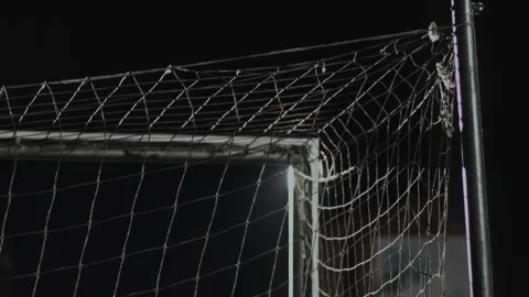 Back side of the top of the corner of goal net during soccer match at night Stock Footage 243161929
