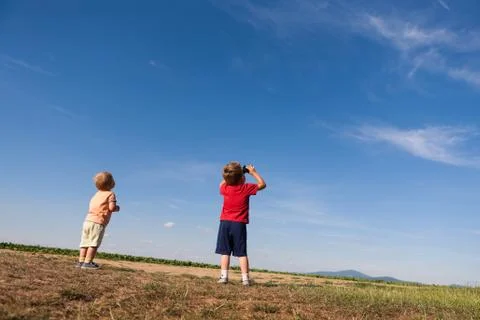Back side of two boys looking at the sky Stock Photos