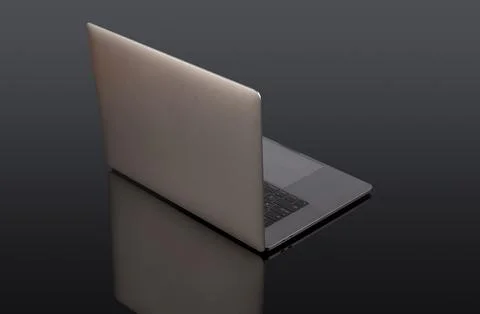Back side view of modern laptop on black office table Stock Photos