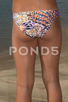 Back side walking on beach, legs walking along sea side. Stock Photos