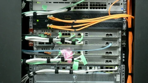 Back side of the working data servers with flashing LED lights and cables. Video stock 102693679