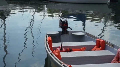 BACK OF SKIFF IN HARBOR DRIFTING ON THE CURRENT Stock Footage 106137211