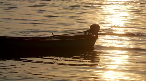 Back of small boat &amp; engine with sea reflected sunset sunbeam Stock Footage 49041712