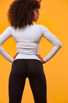 Back of strong athletic woman with black skin and curly hair