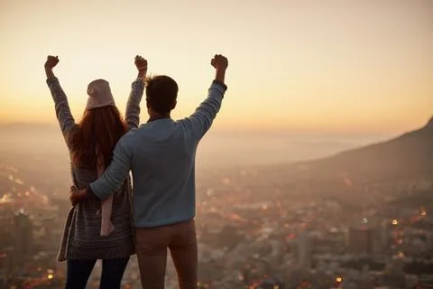Back, sunset and couple with view, cheering and celebration for anniversary.. Stockfoto's