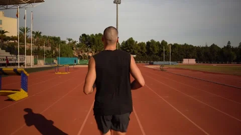 Back tracking of a runner on an athletics track. Concept of sport and effor.. Video stock 267894501
