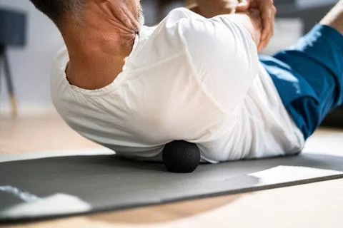Back Trigger Point Massage Using Foam Ball Stock Photos