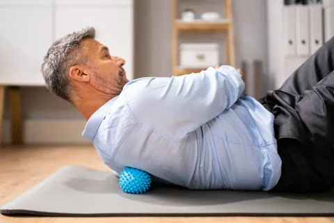 Back Trigger Point Massage Using Spiky Ball Stock Photos