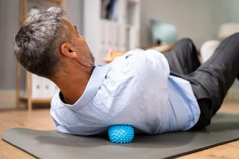 Back Trigger Point Massage Using Spiky Ball Stock Photos