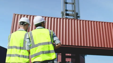 Back of two cargo container workers or engineer men work in front of container Stock-Footage 146474179