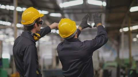 The back of two technician men stand and look to various type of machine Stock-Footage 127812662
