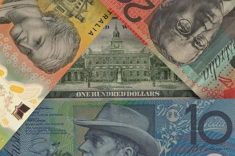 Back of a US $100 bill peeks out from under Australian dollar bills. Foreig.. Stock Photos