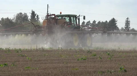 Back of vehicle spreading fertilizer on a farm field of corn stubble. 4K Stock Footage 59643395