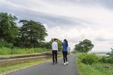 Back view of active asian couple walking exercise at rural area Fotos de archivo
