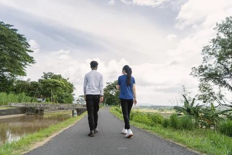 Back view of active asian couple walking exercise at rural area Fotos de archivo