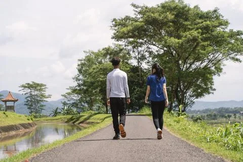 Back view of active asian couple walking exercise at rural area Fotos de archivo