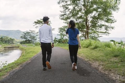 Back view of active asian couple walking exercise at rural area Fotos de archivo