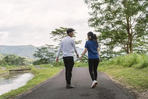 Back view of active asian couple walking exercise at rural area Stock Photos
