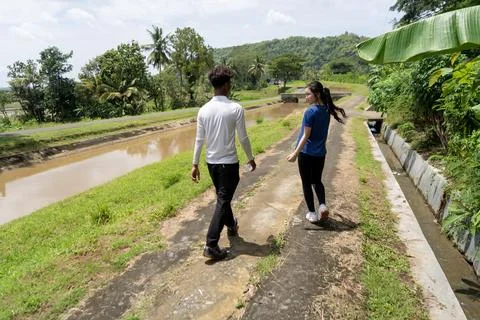 Back view of active asian couple walking exercise at rural area Stock-Fotos