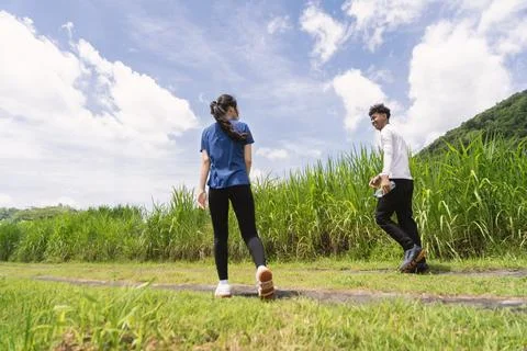 Back view of active asian couple walking exercise at rural area Fotos de archivo