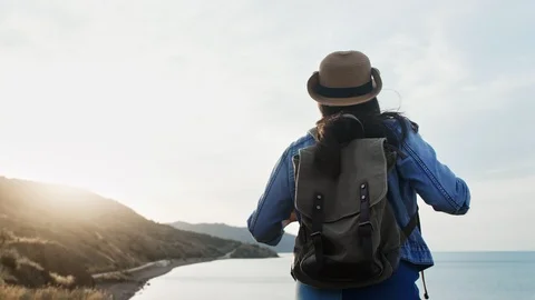Back view active backpacker female approaching sea admiring amazing seascape Stock Footage 111869897
