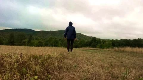 Back View Active Man Going On Glass Field Mountain Cloudy Day Stock Footage 154195207