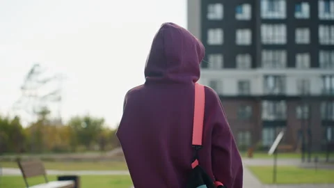 Back View Active Woman Walking Towards Building on Gray Tiled Pavement Stock Footage 316642698