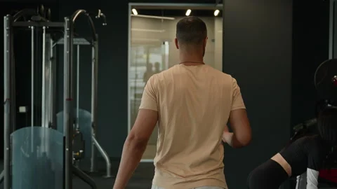 Back view African American man sportsman athletic guy trainer instructor walking Stock Footage 240955830